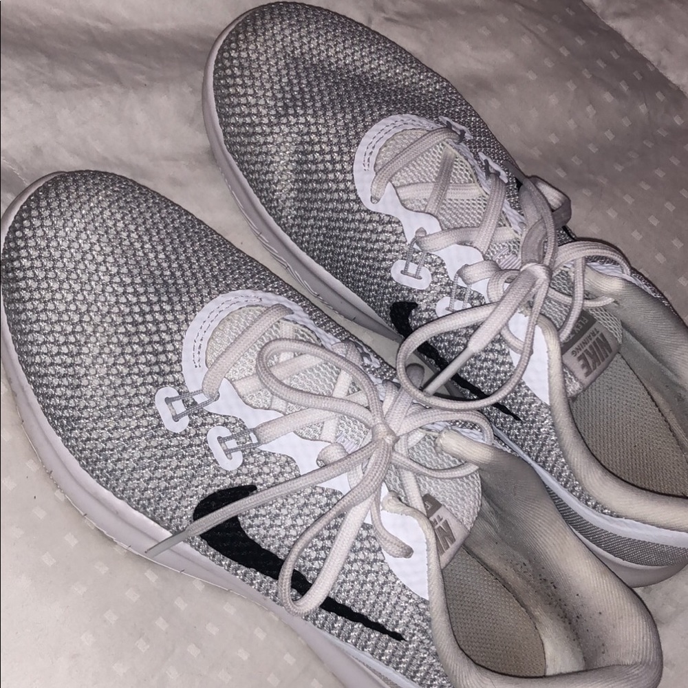 Silver and white Nike tennis shoes